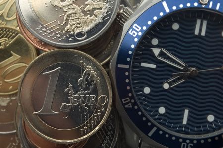 wrist watch and eur coins close up shoot