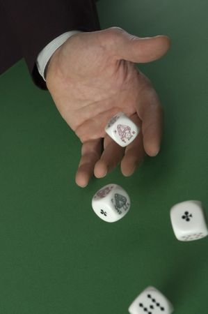 hand throwing dices on green background close upの写真素材