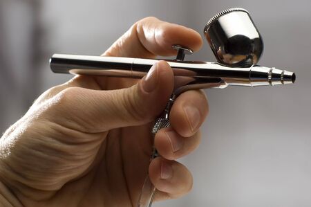 airbrush in man hand close up shootの写真素材