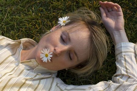 young woman relaxing on the grass close upの写真素材