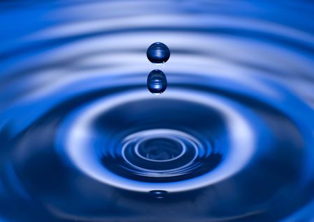 drop of water on blue background close up shootの写真素材