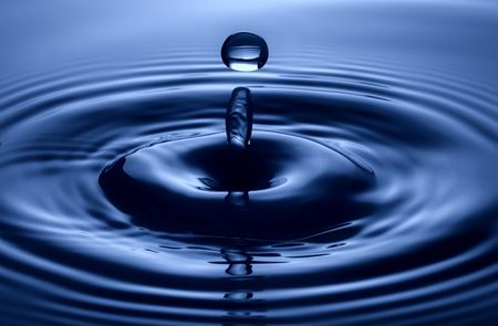 drop of water on blue background close up shoot