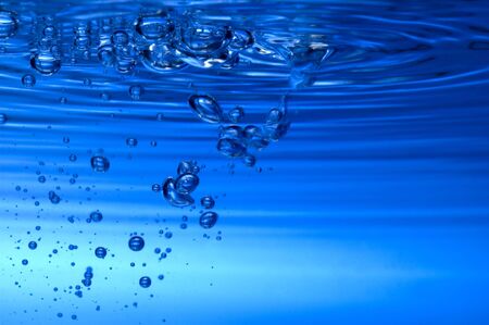 water bubbles on blue background close up
