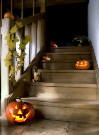 halloween pumpkins on stairs in the house at nightの写真素材