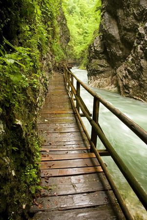 wooden path trough beautiful canyon with riverの写真素材