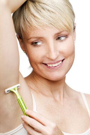 young blond woman shaving close up shootの写真素材