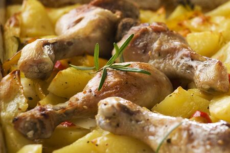 Roasted chicken with potatoes and rosemary close upの写真素材