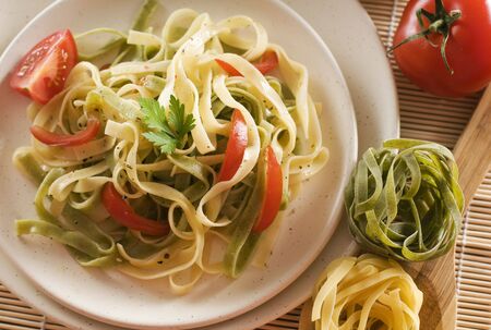 Mixed pasta with tomato and parsley close up shootの写真素材