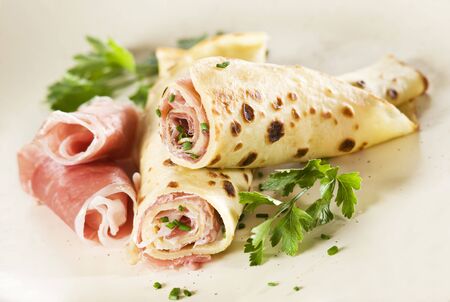 Pancakes filled with curd and prosciutto close upの写真素材