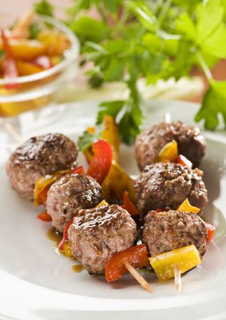 Meat balls with red and yellow peppers close upの写真素材