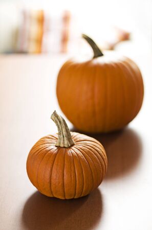 Two orange pumpkins on the table close upの写真素材