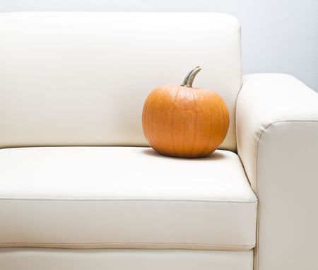 Orange pumpkin on sofa close up shootの写真素材