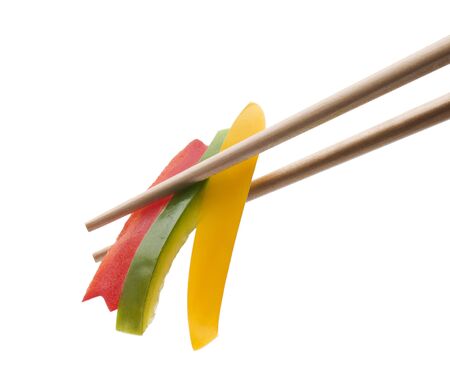 Colorful vegetables with chopsticks close up isolatedの写真素材