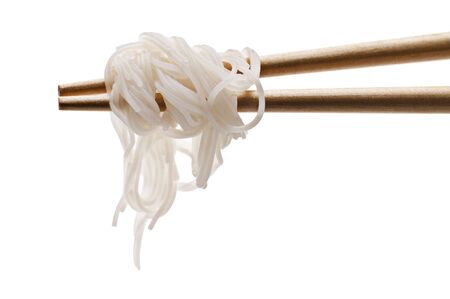 Chopsticks holding oriental noodles isolated on whiteの写真素材