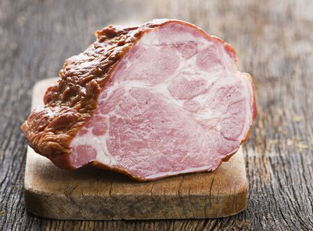 Juicy easter ham on wooden background close up