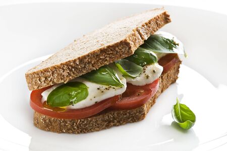 Mozzarella, tomato and basil sandwich close upの写真素材