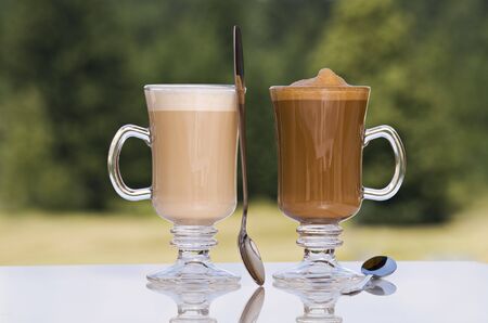 Fresh coffee latte in tall glass outdoor close upの写真素材