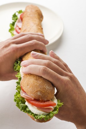 Man holding big sandwich close up shootの写真素材
