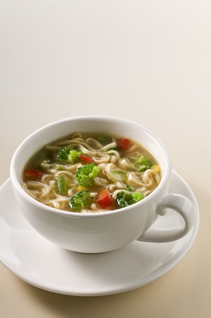 Fresh hot soup with noodles and vegetables close upの写真素材