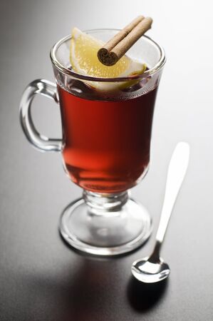 Cup of tea with lemon and cinnamon close upの写真素材
