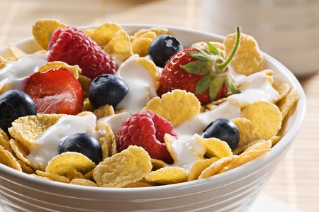 Corn flakes with berries and yogurt close up 