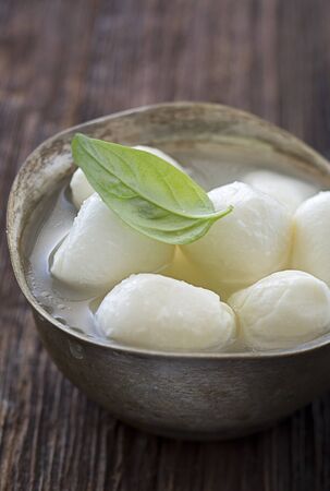 Mozzarella cheese in silver bowl close upの写真素材