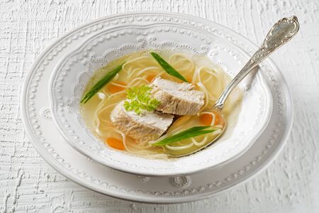 Chicken soup with noodles and meat close up shootの写真素材