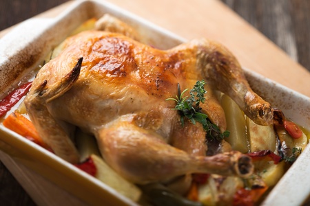 Whole roasted chicken with herbs close up shootの写真素材