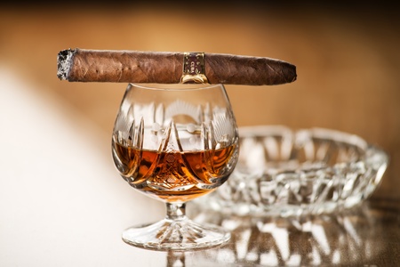 Beautiful cognac with cuban cigar close up shootの写真素材