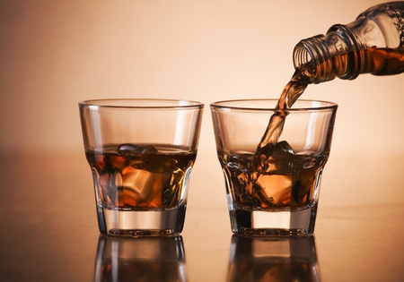 Whiskey pouring into glass close up shootの写真素材