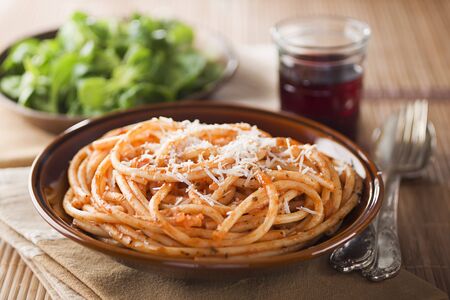 Fresh spaghetti with tomato sauce and parmesan close upの写真素材
