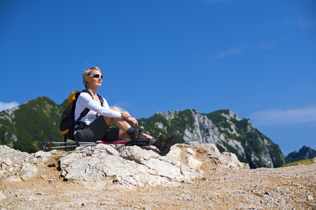 Young woman on a sunny day hiking in high mountainsの写真素材
