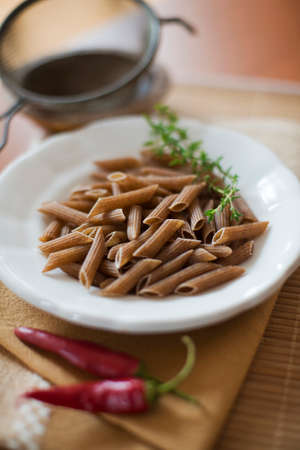 Raw whole grain pasta close up shootの写真素材