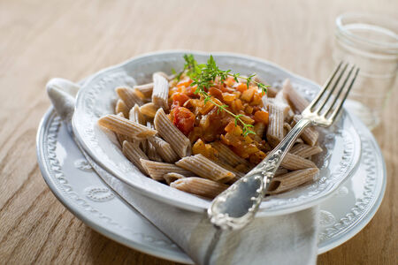 Whole grain pasta with tomato sauce close up shootの写真素材