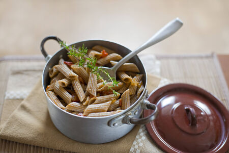 Whole grain pasta with tomato sauce close up shootの写真素材