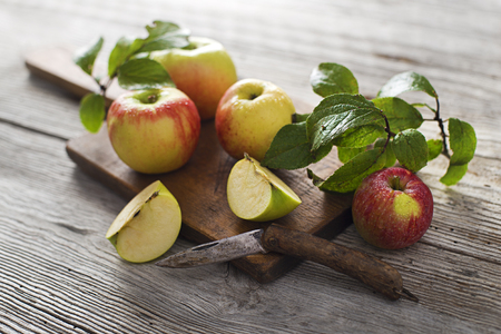 Organic apples on wooden background close upの写真素材