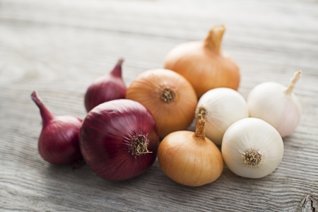 Onions on wooden background close up shootの写真素材
