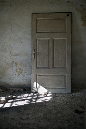 Old door in abandoned house close upの写真素材