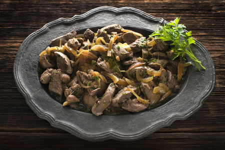 Roasted livers with onion and parsley close upの写真素材