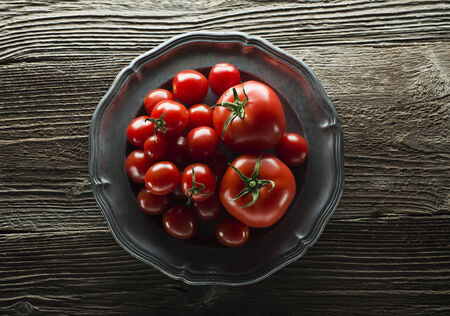 Fresh ripe tomatoes on wooden background close upの写真素材