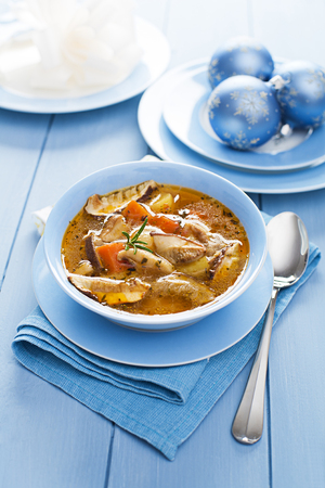 Hot mushroom soup decorated on blue backgroundの写真素材
