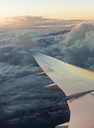 View of airplane wing with cloud patternsの写真素材