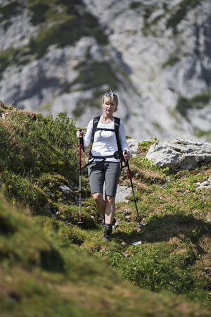 Young woman on a sunny day hiking in high mountainsの写真素材