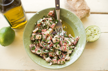 Fresh octopus salad with garlic, parsley, lime and olive oilの写真素材