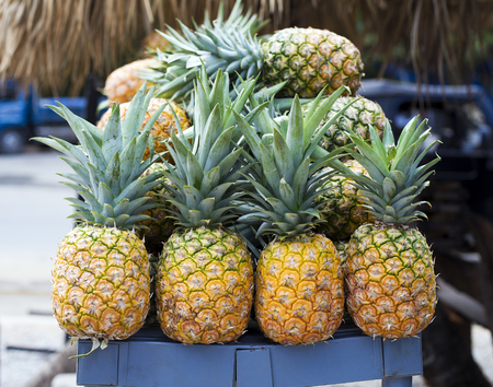 Pile of pineapples at street market, closeupの写真素材