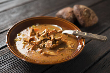 Fresh mushroom soup on wooden background close upの写真素材