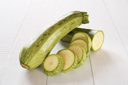 fresh vegetable zucchini sliced on wooden backgroundの写真素材
