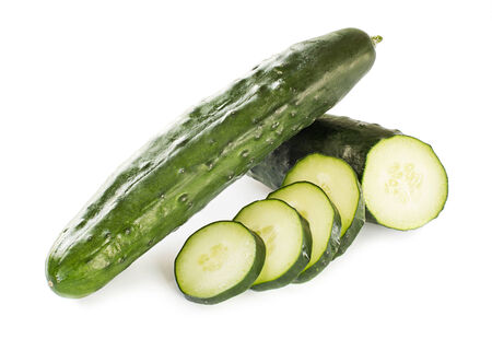 Cucumber and slices isolated over white backgroundの写真素材