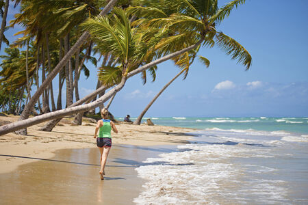 runner on a sunny day jogging on the beachの写真素材