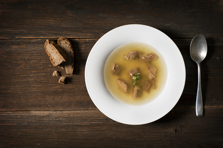 Fresh beef soup on wooden background overhead shootの写真素材